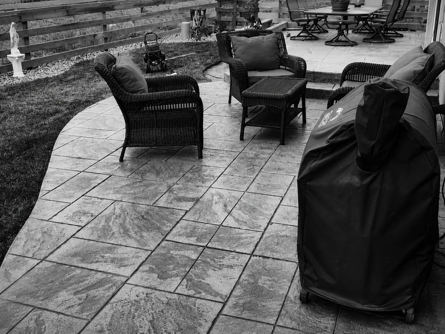 Stamped concrete patio with outdoor furniture built by an outdoor living contractor